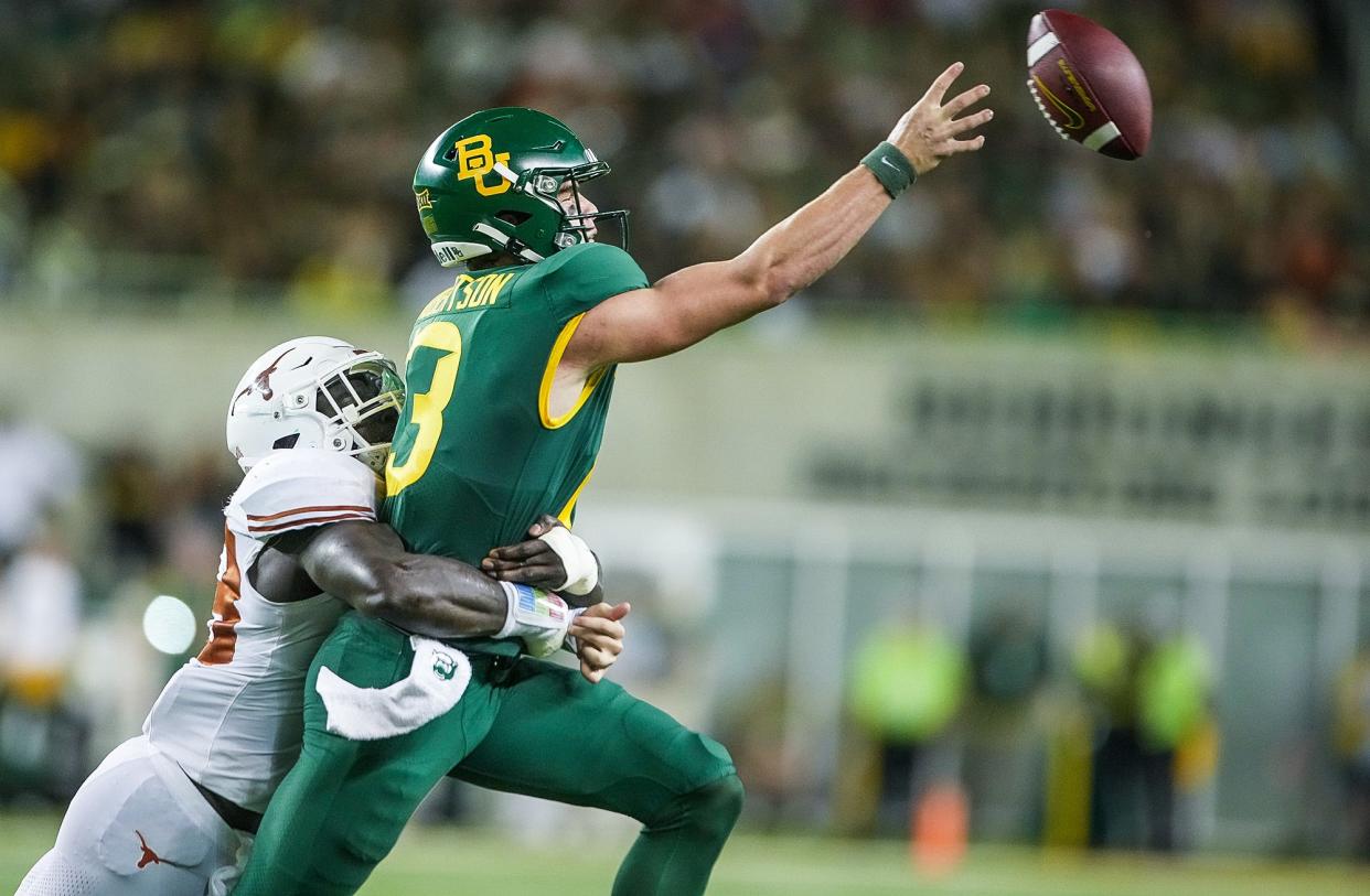 Texas linebacker David Gbenda pressures Baylor quarterback Sawyer Robertson during the Longhorns' win in Waco last season. Gbenda will pair with Anthony Hill Jr. to form a solid group of linebackers in the heart of the UT defense this fall.