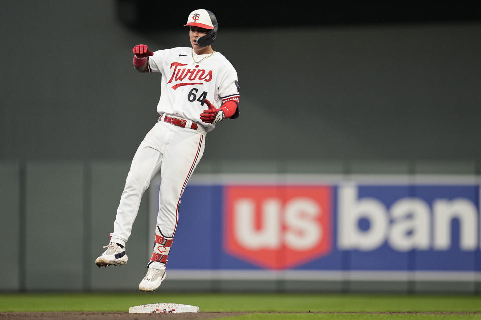 Minnesota Twins' Jose Miranda (64) celebrates after hitting a RBI-double during the fourth inning of a baseball game against the San Diego Padres, Tuesday, May 9, 2023, in Minneapolis. (AP Photo/Abbie Parr)