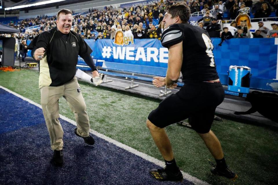 Boyle County head coach Justin Haddix and quarterback Jagger Gillis (9) celebrate after winning the Class 4A championship Friday night. Gillis rushed for two touchdowns and passed for two and received the game’s most valuable player award.