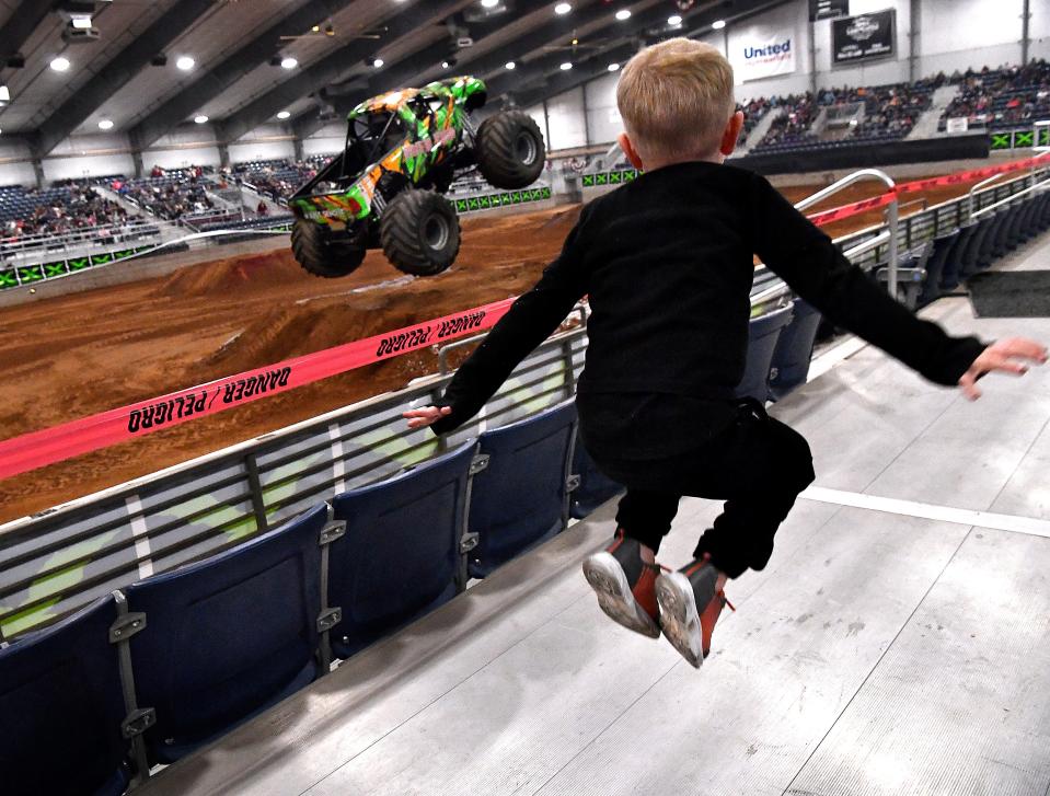 Luke Wagner, 4, jumps in tandem with Prime Time, one of the monster trucks he came from Colorado City to see with his mother Bailey Sprague Saturday Feb. 25.
