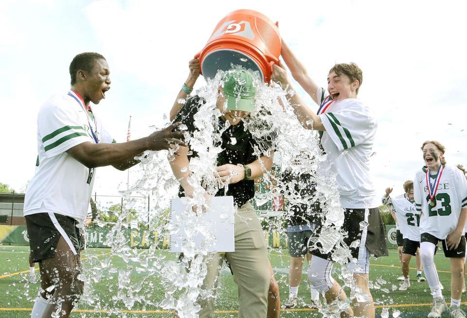 Rice coach Luc LeBlanc receives a gatorade shower after the Green Knights 10-7 win over Hartford in the D2 State Championship game at UVM's Virtue Field.