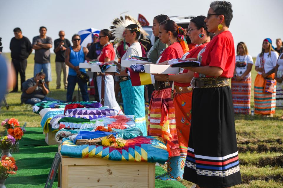 Members of the tribal color guard hold an American flag, a prayer flag and the Rosebud Sioux tribal flag during a funeral ceremony for the remains of nine Rosebud Sioux children finally returned home from the Carlisle Indian Industrial School on Saturday, July 17, at the Rosebud Sioux Tribe Veterans Cemetery. 
In 1880, the children were brought to the former boarding school in Carlisle, Pennsylvania. Some died from illness within months of arriving, others died years later after failed attempts of escaping the horrors of the school meant to kill the Indian, save the man. This was the final stop for the children 142 years later after an emotional community journey by caravan across the country from Pennsylvania to South Dakota to bring their remains home.