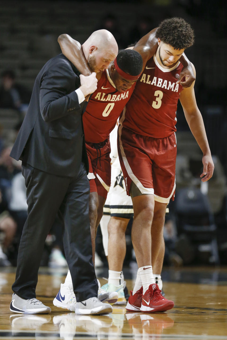 Alabama forward Javian Davis (0) is helped off the court after being injured in the second half of an NCAA college basketball game against Vanderbilt Wednesday, Jan. 22, 2020, in Nashville, Tenn. Alabama won 77-62. (AP Photo/Mark Humphrey)