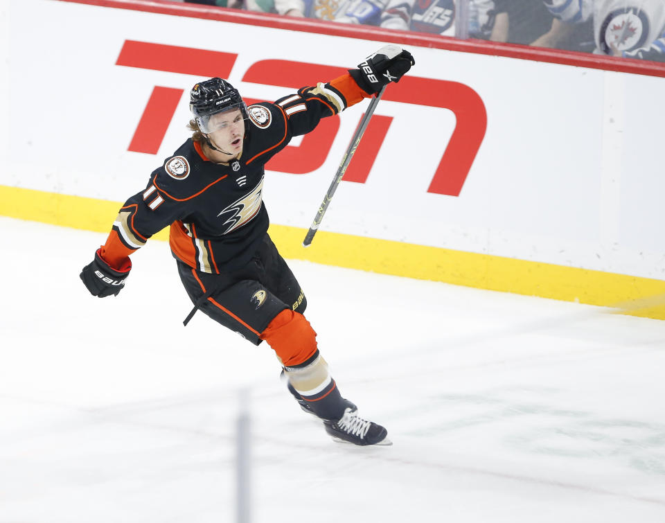 Anaheim Ducks' Trevor Zegras (11) scores the tying goal against Winnipeg Jets goaltender Connor Hellebuyck during third-period NHL hockey game action in Winnipeg, Manitoba, Thursday, Nov. 17, 2022. (John Woods/The Canadian Press via AP)