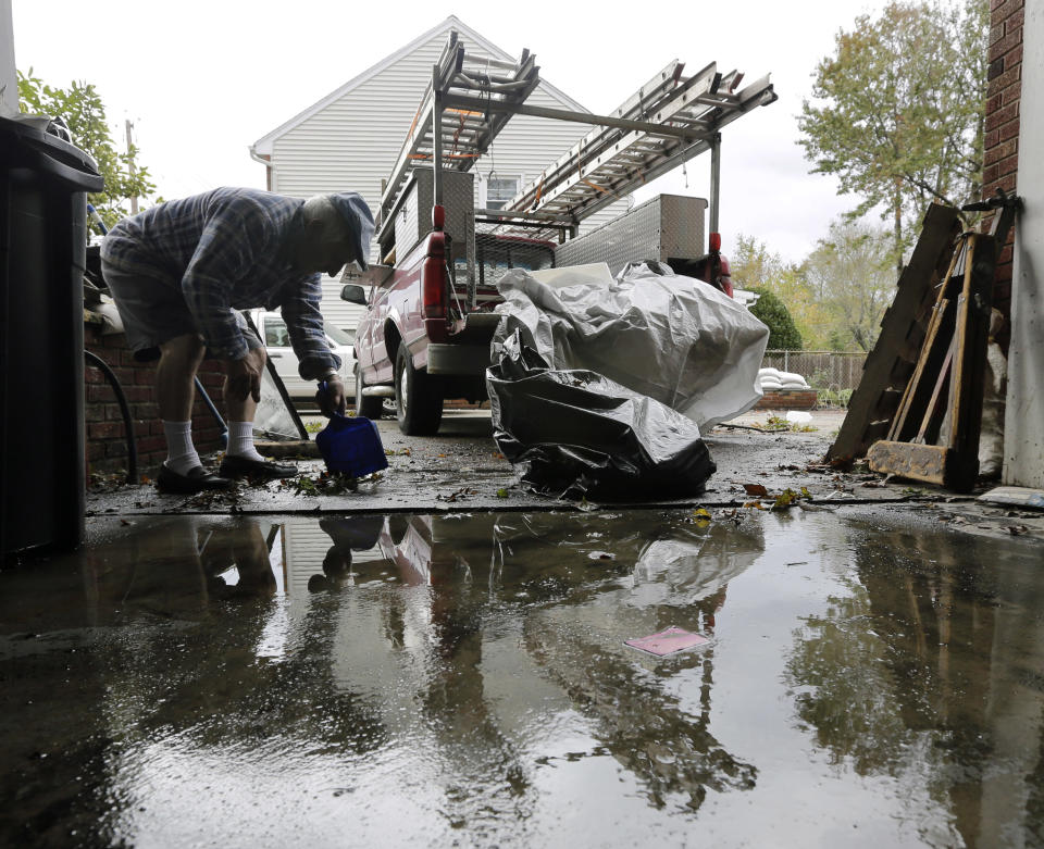 Charlie DiBuono cleans mud and debris from his flooded garage in the wake of superstorm Sandy on Thursday, Nov. 1, 2012, in Little Ferry, N.J. Surprise coastal surge floods caused by the storm battered Little Ferry, Moonachie and some other towns along the Hackensack River in Bergen County _ all areas unaccustomed to flooding. (AP Photo/Mike Groll)