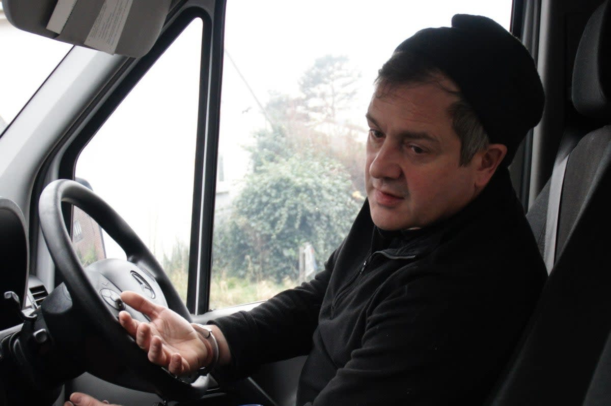 Cash-in-transit driver Andrew Measor pictured handcuffed to the steering wheel after the fake robbery (PA)