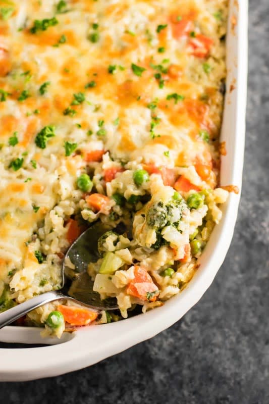 <p>Deliciously cheesy rice and vegetable casserole. A great go to casserole dish to feed a crowd! You can’t go wrong with this classic favorite vegetable side dish.</p><p><strong>Get the recipe: <a href="https://buildyourbite.com/creamy-vegetable-and-rice-casserole/" rel="nofollow noopener" target="_blank" data-ylk="slk:Creamy Vegetable and Rice Casserole;elm:context_link;itc:0;sec:content-canvas" class="link rapid-noclick-resp">Creamy Vegetable and Rice Casserole</a></strong></p>