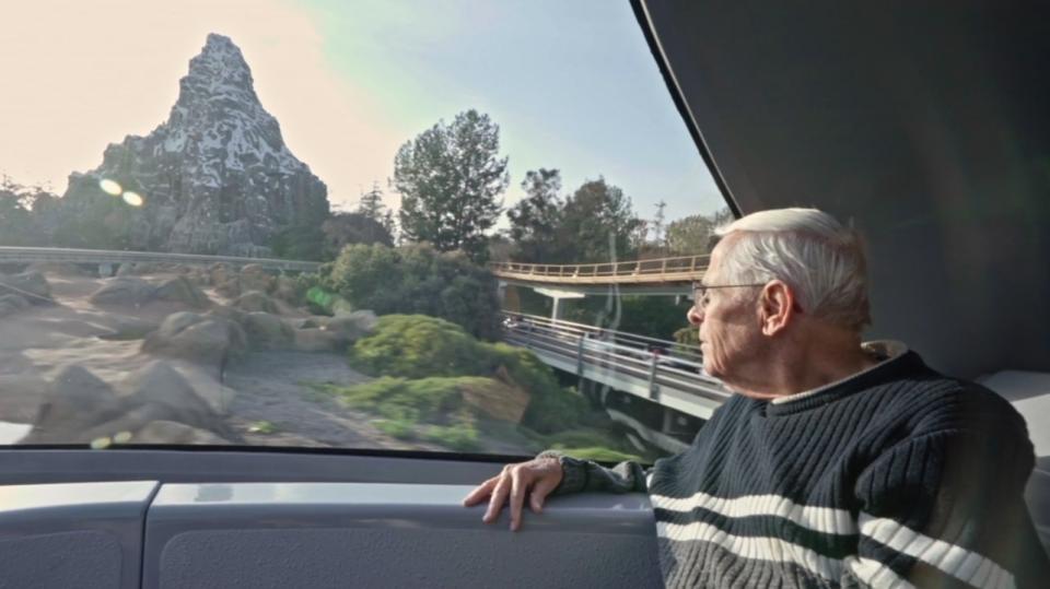 Bob Gurr sitting on Monorail looking at Matterhorn in The Imagineering Story