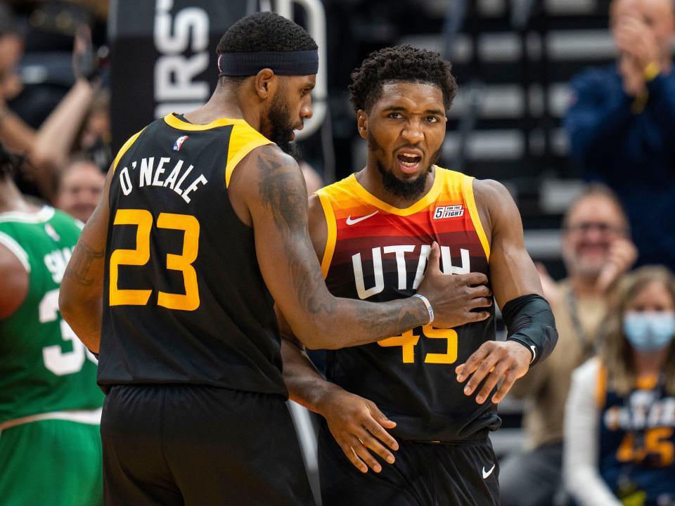 Utah Jazz forward Royce O'Neale (23) pats Utah Jazz guard Donovan Mitchell (45), who is fired up after scoring and being fouled in the final minutes of the game, in the second half during an NBA basketball game Friday, Dec. 3, 2021, in Salt Lake City. (AP Photo/Rick Egan).