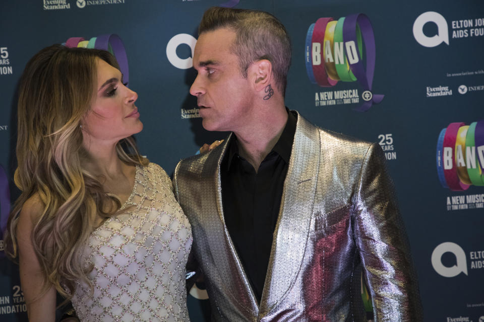 Singer Robbie Williams, right, and actress Ayda Field pose for photographers upon arrival at the premiere of the musical 'The Band', in London, Tuesday, Dec. 4, 2018. (Photo by Vianney Le Caer/Invision/AP)