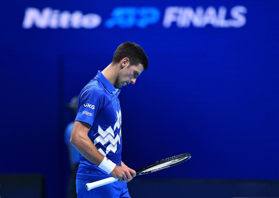 Novak Djokovic looks at his racquet in between points during the match against Daniil Medvedev.