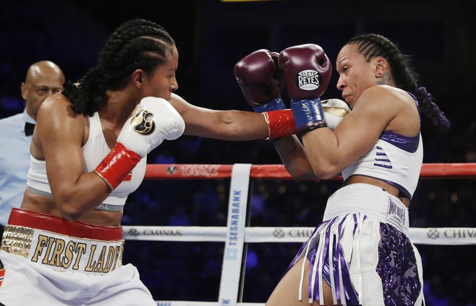 Cecilia Braekhus hits Kali Reis during their female welterweight championship boxing match Saturday in Carson, California. (AP)