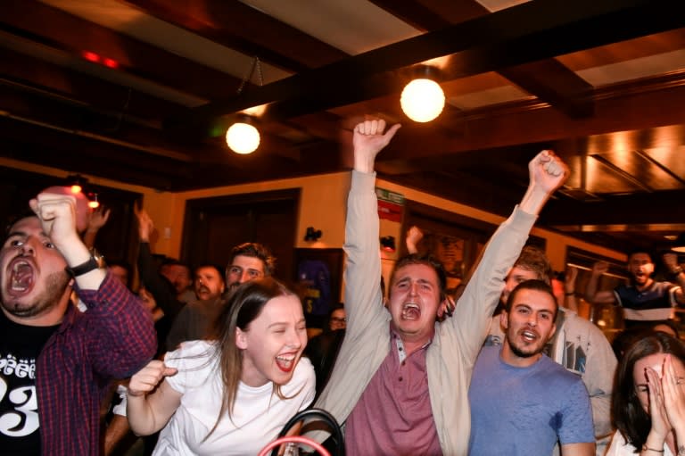 Kosovo Albanian supporters of Switzerland celebrate the winning goal scored by Xherdan Shaqiri in the World Cup Group E game between Serbia and Switzerland as they watch on TV in a pub in Pristina on June 22, 2018