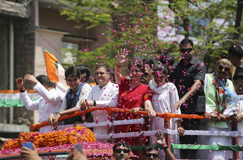 In this April 10, 2019, photo, Congress party chief Rahul Gandhi, center in white, accompanied by his sister Priyanka Vadra in red arrives to file his nomination papers for the upcoming general elections in Amethi, Uttar Pradesh state, India. (AP Photo/Rajesh Kumar Singh, File)