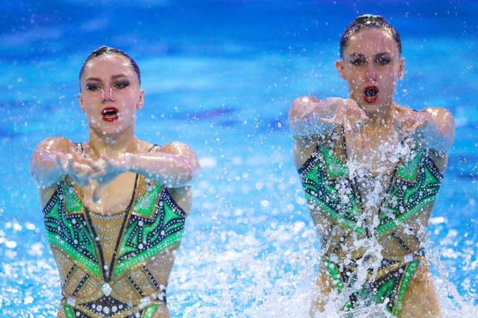 Laura and Charlotte Tremble compete in synchronized swimming