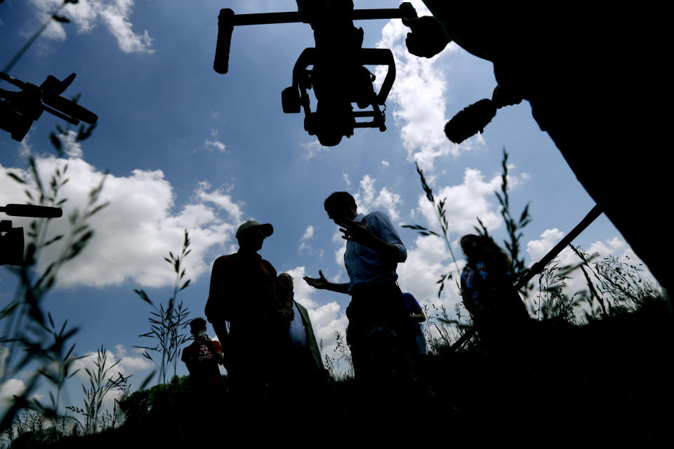 Democratic presidential candidate Beto O'Rourke talks with Matt Russell, left, while touring his Coyote Run Farm, Friday, June 7, 2019, in Lacona, Iowa. (AP Photo/Charlie Neibergall)