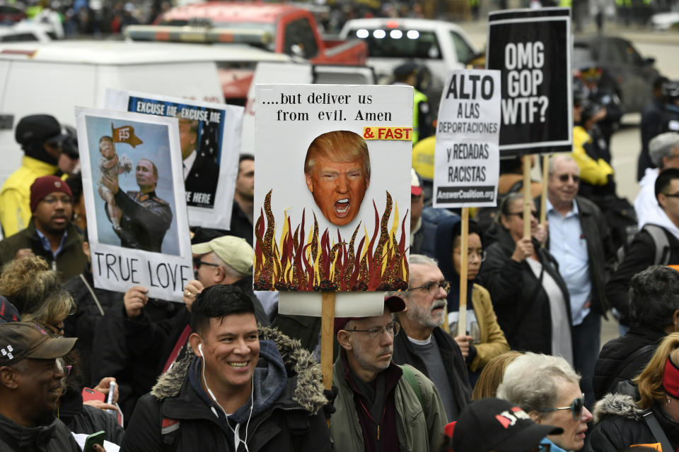 Protesters gather across the Chicago River from the Trump International Hotel and Tower while President Trump attends a fundraiser Monday, Oct. 28, 2019, in Chicago. (AP Photo/Paul Beaty)