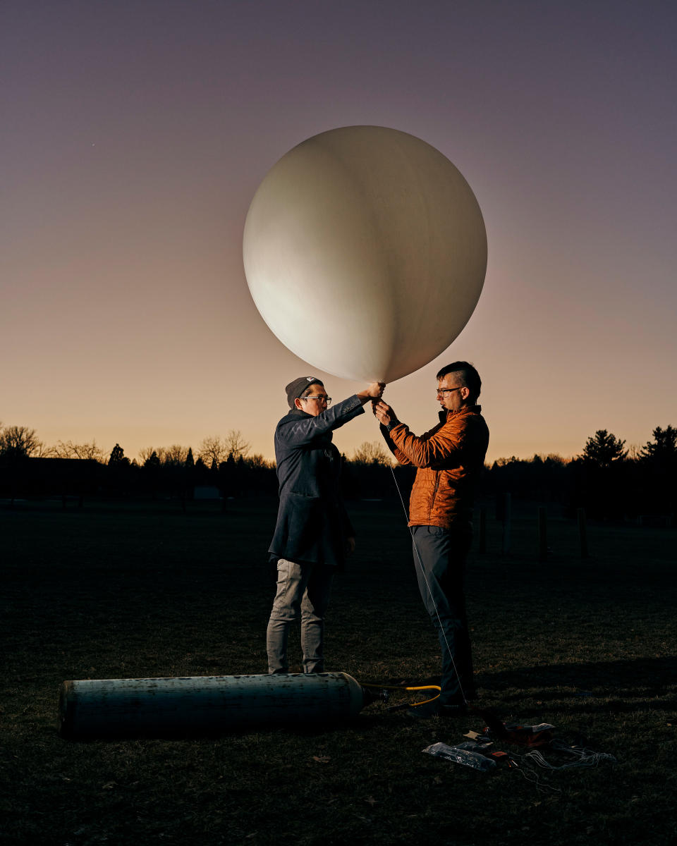 Founder Luke Iseman and co-founder Andrew Song of solar geoengineering startup Make Sunsets hold a weather balloon filled with helium, air, and sulfur dioxide at a park in Reno, Nevada on February 12, 2023.<span class="copyright">Balazs Gardi for TIME</span>