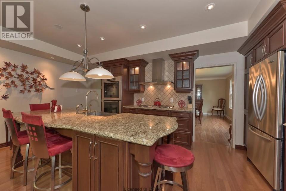 <p><span>1058 Fraser Ave., London, Ont.</span><br> The gourmet kitchen features granite counters, a second sink for prep, cherry cabinetry and a Miele five-burner gas cooktop, all adjoining a formal dining room.<br> (Photo: Zoocasa) </p>