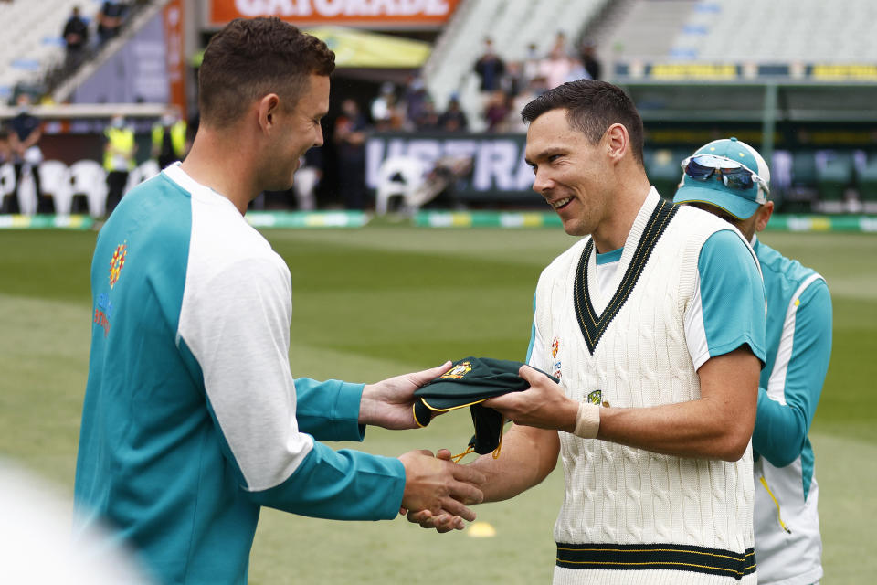 Pictured right, Test debutant Scott Boland receives his 'Baggy Green' cap from Josh Hazlewood before day one of the third Ashes Test at the MCG in 2021