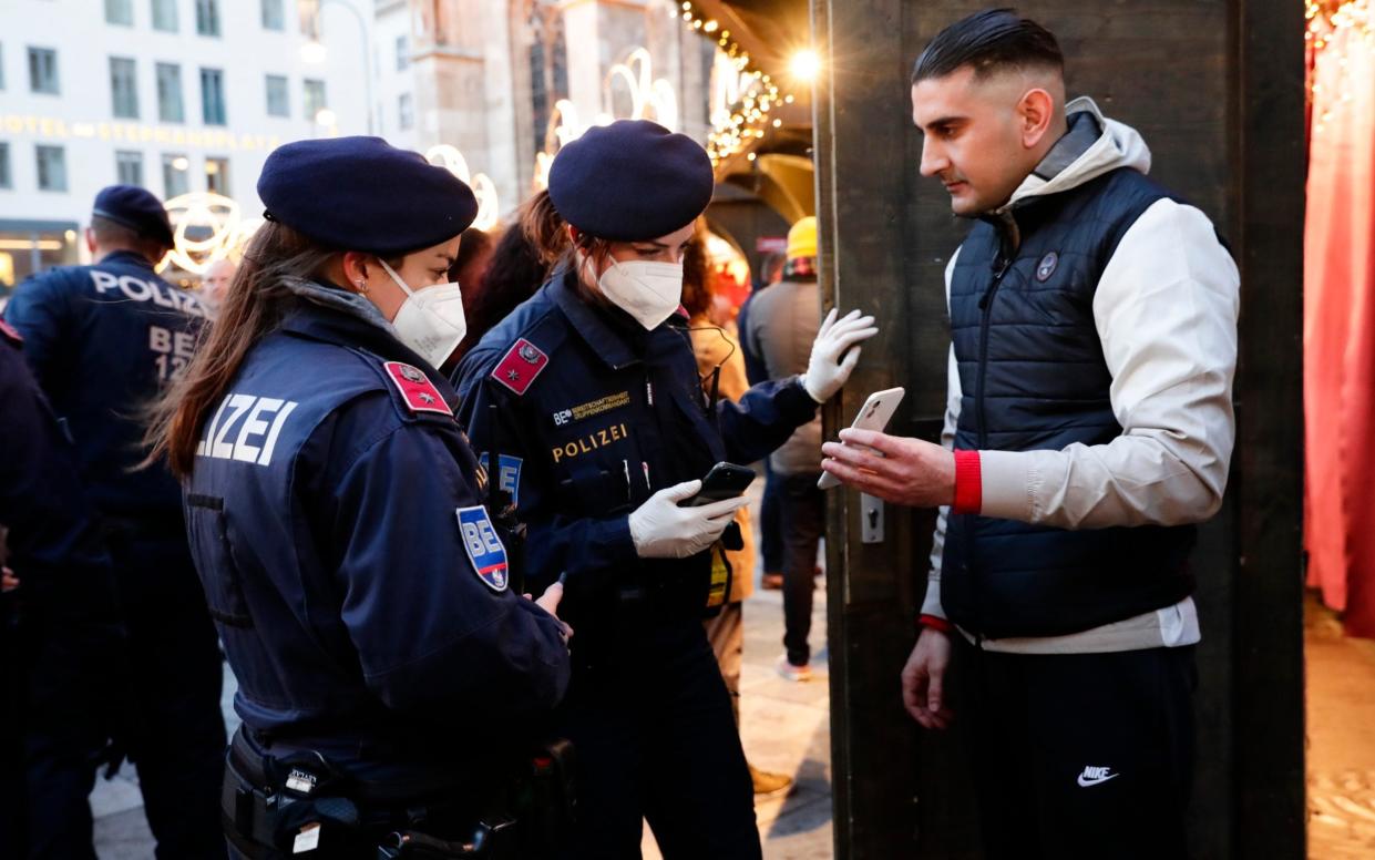 Police officers patrol the streets to check vaccine certificates in Vienna on Friday - AP