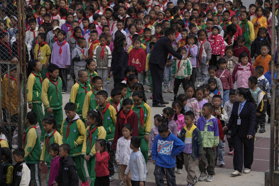 Tibetan students line up as they head for their meals at the Shangri-La Key Boarding School during a media-organized tour in Dabpa county, Kardze Prefecture, Sichuan province, China on Sept. 5, 2023. (AP Photo/Andy Wong)