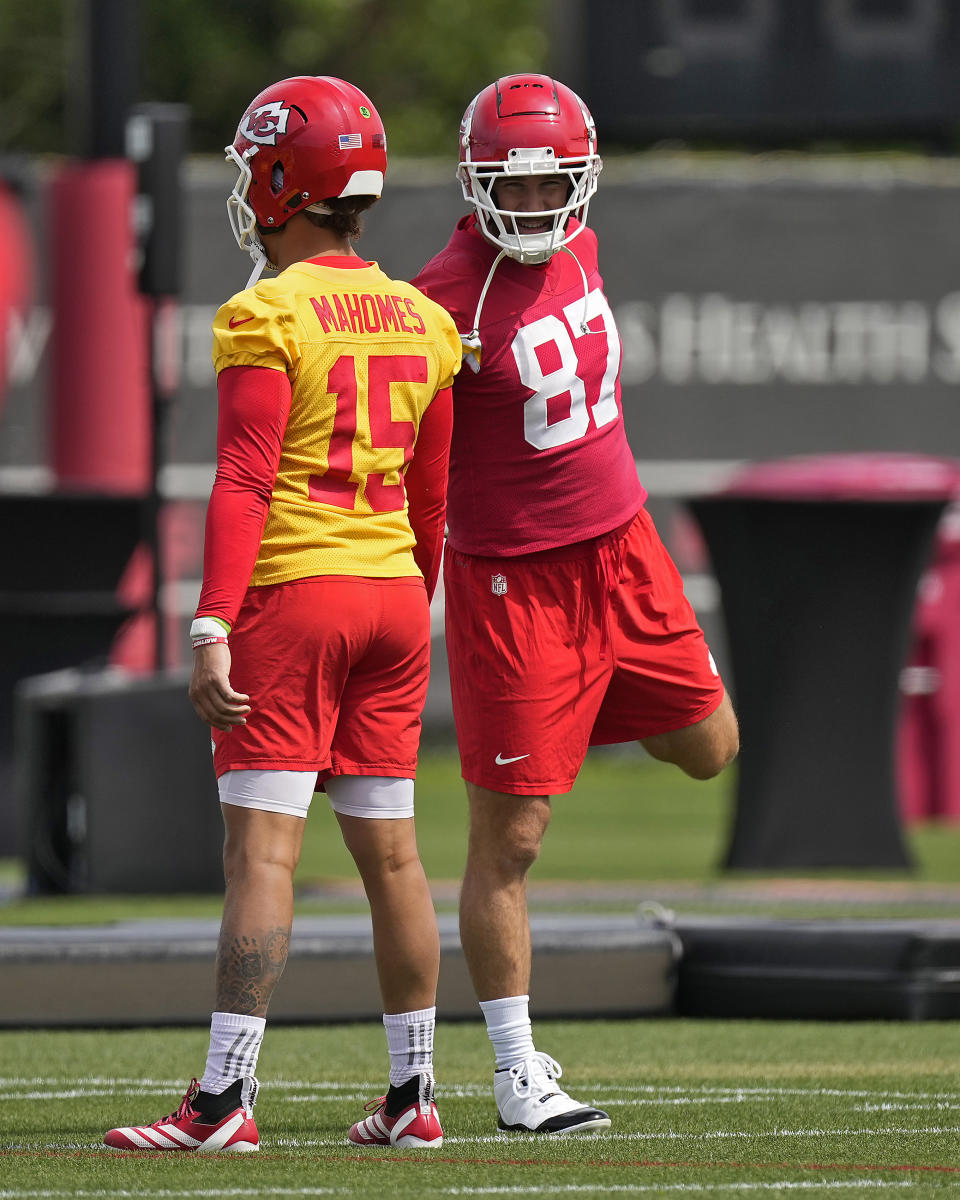 Kansas City Chiefs quarterback Patrick Mahomes (15) and tight end Travis Kelce (87) talk during NFL football practice Tuesday, June 11, 2024, in Kansas City, Mo. (AP Photo/Charlie Riedel)