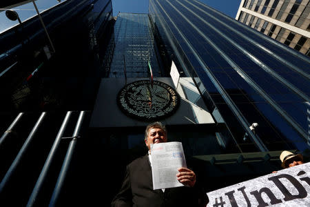 Jaime Martinez, head of the federally-run Commission for Dialogue with Indigenous People stands outside the Mexico's attorney general's office as he holds his complaint against Trump in Mexico City, Mexico January 25, 2017. REUTERS/Carlos Jasso