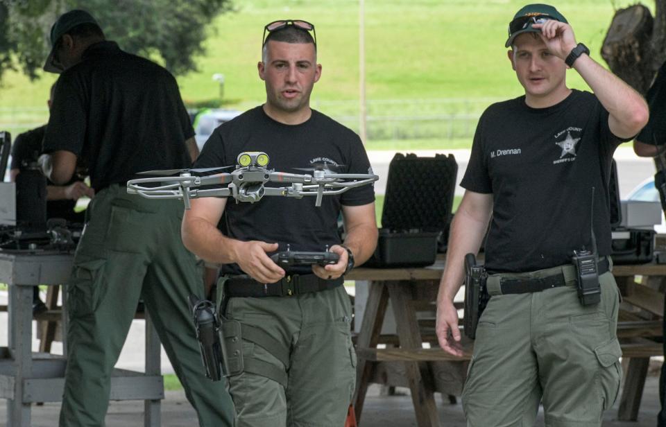In this file photo from July 2021, Lake County Sheriff’s Deputy Joey Rempel flies a drone as Deputy Matthew Drennan watches during a training session at the Lake Technical College Institute of Public Safety weapons and driving range in Tavares.