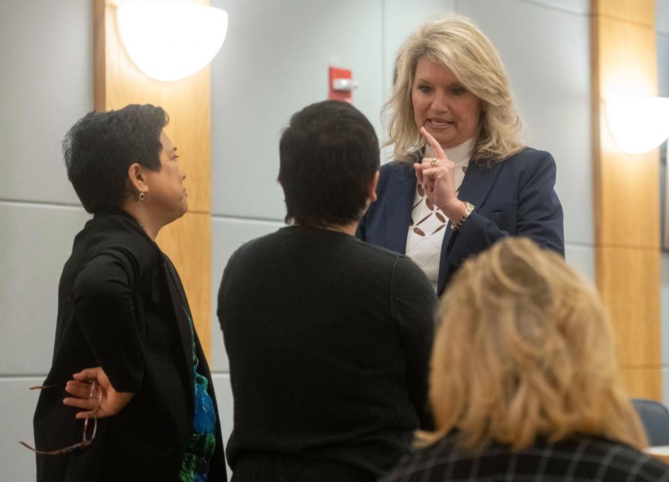 Escambia County Clerk of Court Pam Childers consults with her legal team before a hearing before Judge William Stone on Monday, Feb. 26, 2024.