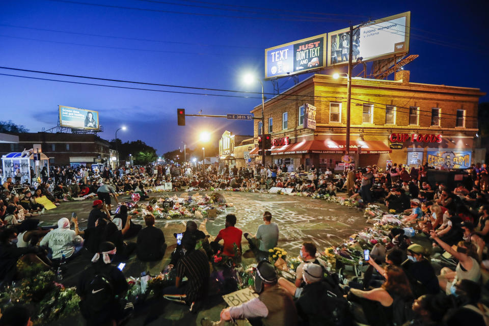 Image: Protesters at a June memorial for George Floyd in Minneapolis (John Minchillo / AP)