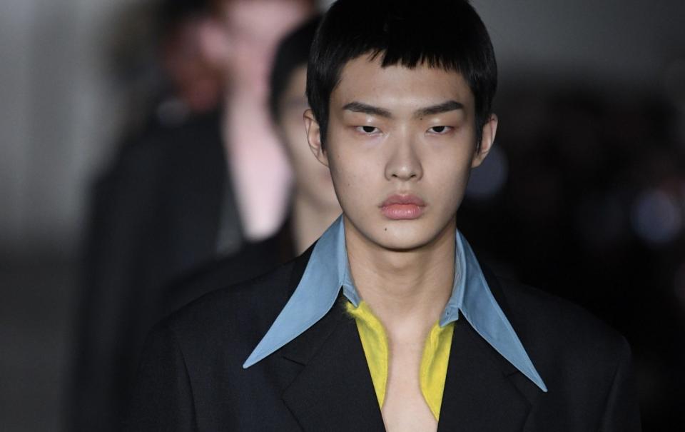 Similarly, large lapels and suiting are hallmarks of the Prada Men's Collection.