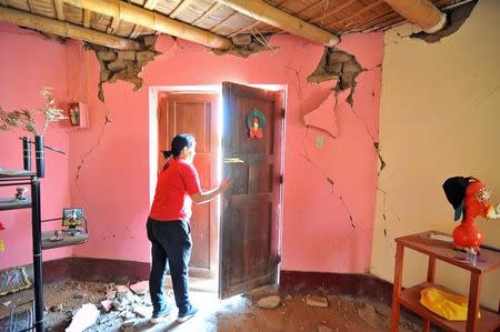 A woman is seen in a building after a strong magnitude 7.1 earthquake struck the coast of southern Peru, in Acari, Arequipa, Peru, January 14, 2018. REUTERS/Diego Ramos