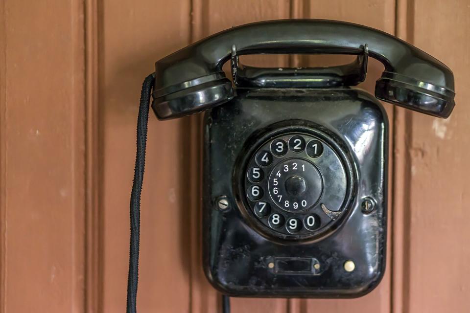 Dialing a rotary phone.