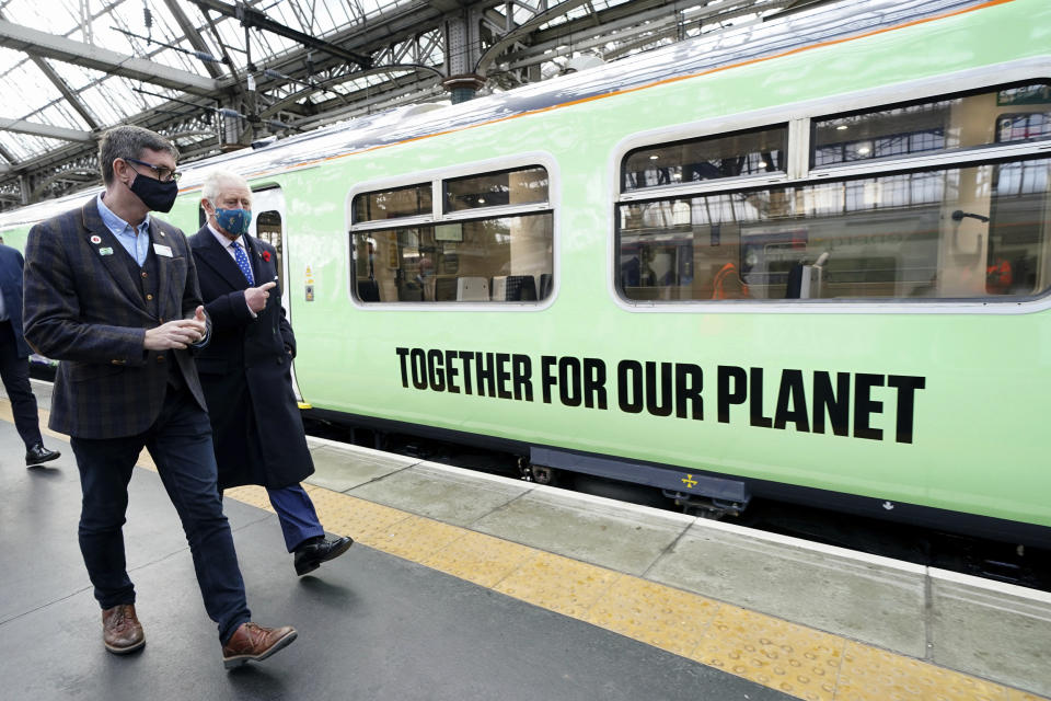 FILE - Britain's then-Prince Charles walks alongside a hydrogen powered train with Martin Frobisher, Network Rail group engineering director at Glasgow Central Station, on the sidelines of the COP26 UN Climate Change Conference, in Glasgow, Scotland, Nov. 5, 2021. Now that he's monarch, King Charles III — one of Britain's most prominent environmental voices — will be have to be more careful with his words.(Jane Barlow, Pool Photo via AP, File)