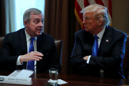 U.S. President Donald Trump, flanked by U.S. Senator Dick Durbin (D-IL), holds a bipartisan meeting with legislators on immigration reform at the White House in Washington, U.S. January 9, 2018. REUTERS/Jonathan Ernst