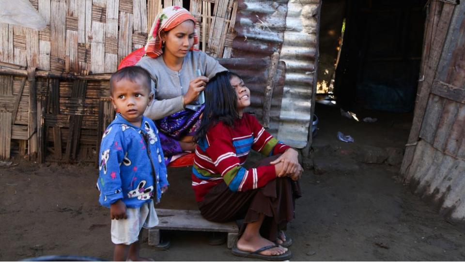 Rohingya family gather outside their residence in Baw Du Pha IDP camp on December 18, 2021, in Sittwe, Rakhine State.