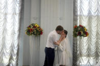 Kateryna Lytvynenko and Ihor Zakvatskyi kiss after getting married in Kyiv, Ukraine, Wednesday, June 15, 2022. Ihor proposed to Kateryna on the day the war started. A growing number of couples in Ukraine are speedily turning love into matrimony because of the war with Russia. Some are soldiers, marrying just before they head off to fight. Others are united in determination that living and loving to the full are more important than ever in the face of death and destruction. (AP Photo/Natacha Pisarenko)