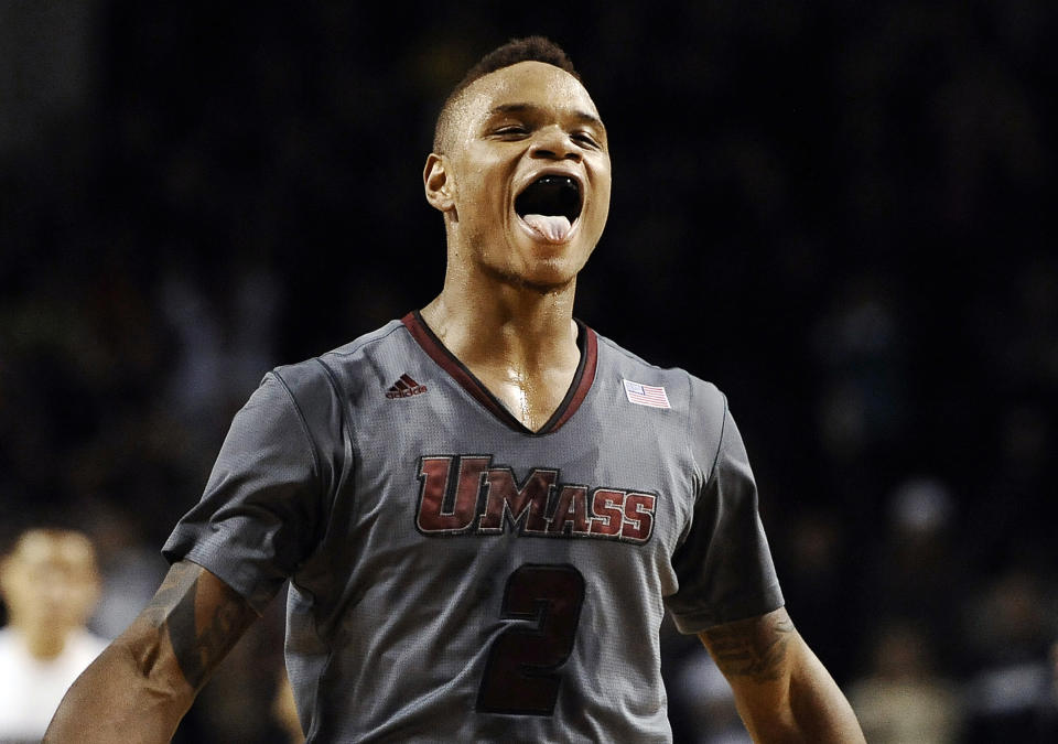 In this Dec. 28, 2013 file photo, UMass guard Derrick Gordon celebrates after hitting the go-ahead basket with one second left on the clock during overtime of an NCAA college basketball game against Providence, in Amherst, Mass. Gordon says in a televised interview that he is gay. Gordon made the announcement on ESPN on Wednesday, April 9, 2014, becoming the first openly gay player in Division I men's basketball. (AP Photo/Jessica Hill, File)