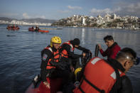 Firefighters and scuba divers search for bodies near sunken boats at a yacht club in Acapulco, Mexico, Saturday, Oct. 28, 2023, following Hurricane Otis. (AP Photo/Felix Marquez)