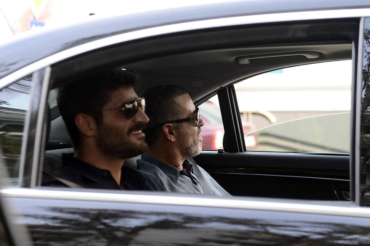 VIENNA, AUSTRIA - SEPTEMBER 04:  George Michael and  Fadi Fawaz arrive at Airport Vienna on September 4, 2012 in Vienna, Austria.  (Photo by Luca Teuchmann/Getty Images)