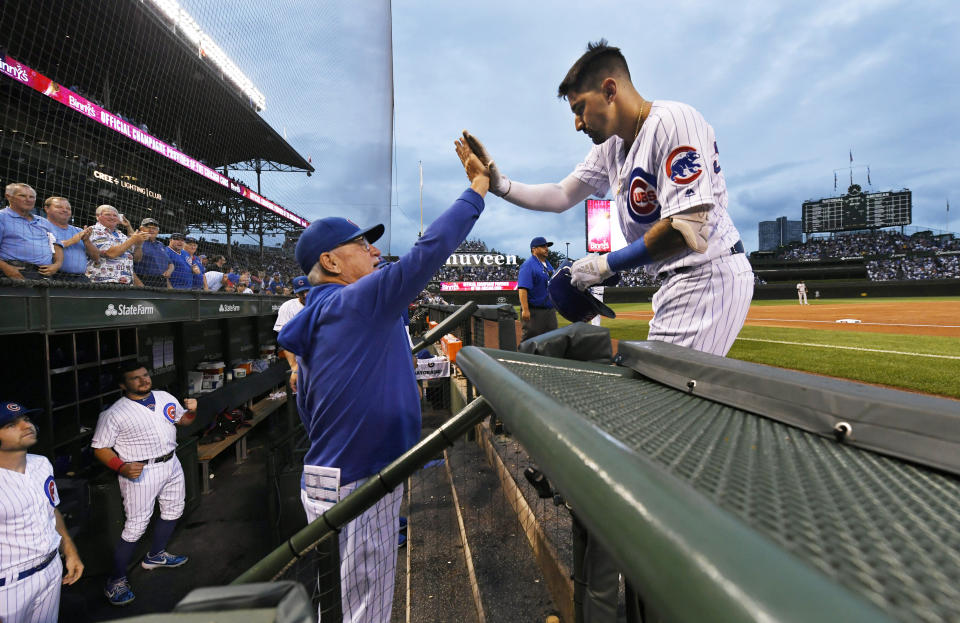 Chicago Cubs' Nicholas Castellanos right, celebrates with manager Joe Maddon at the dugout after hitting a two-run home run during the first inning of the team's baseball game against the San Francisco Giants on Wednesday, Aug 21, 2019, in Chicago. (AP Photo/Paul Beaty)