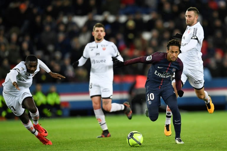 Paris Saint-Germain's forward Neymar (R) makes his way through the defence during the French L1 football match against Dijon January 17, 2018