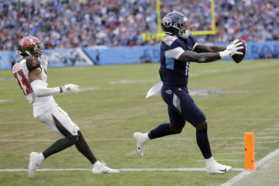 Tennessee Titans wide receiver A.J. Brown (11) catches an 8-yard touchdown pass ahead of Tampa Bay Buccaneers cornerback Carlton Davis (33) in the second half of an NFL football game Sunday, Oct. 27, 2019, in Nashville, Tenn. (AP Photo/James Kenney)