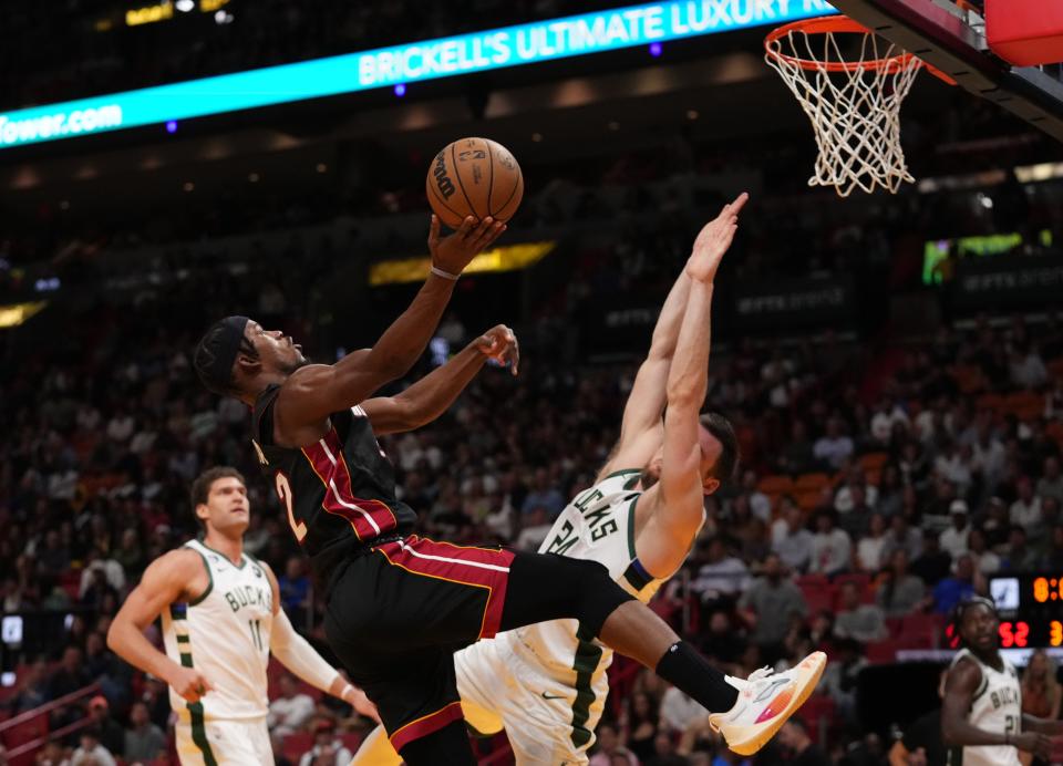 Heat forward Jimmy Butler puts up an off-balance shot in lane against Bucks guard Pat Connaughton on Thursday night.