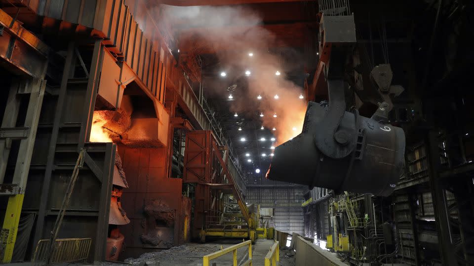 A giant ladle backs away after pouring its contents of red-hot iron into a vessel in the basic oxygen furnace as part of the process of producing steel at the US Steel Granite City Works facility in a 2018 file photo. - Jeff Roberson/AP