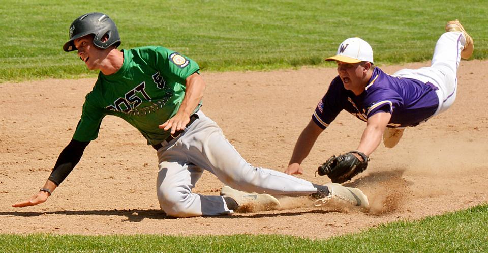 Watertown Post 17’s Kale Stevenson (right) dives to tag out a Pierre base runner during a 2021 American Legion baseball doubleheader at Watertown Stadium.