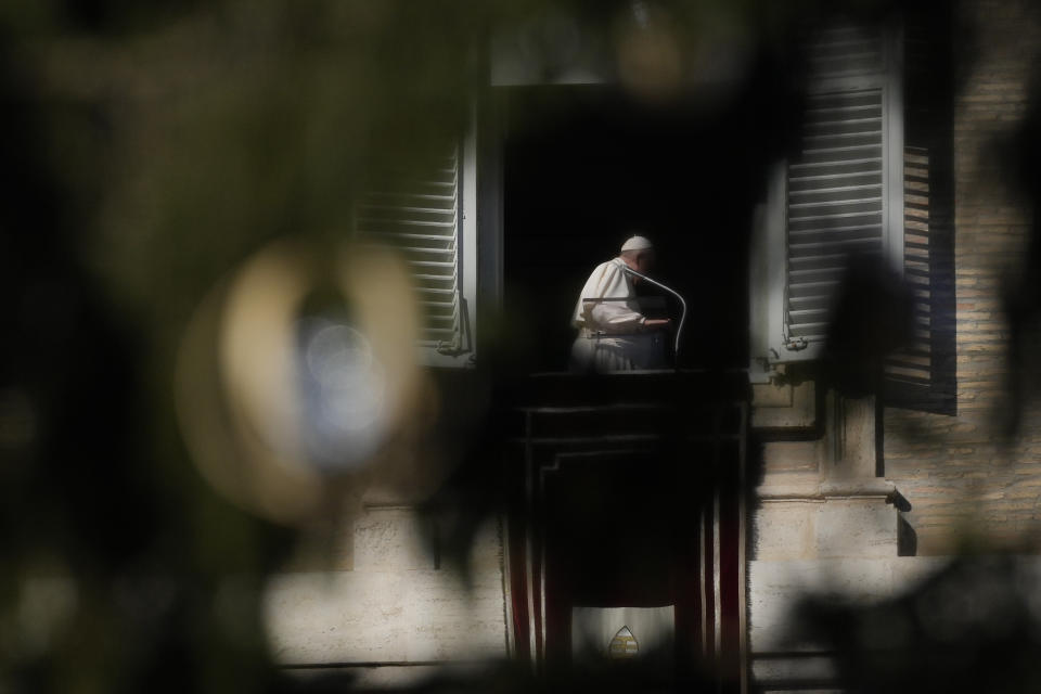 Pope Francis, framed by the Vatican Christmas tree, leaves at the end of the Angelus noon prayer from the window of his studio overlooking St.Peter's Square, at the Vatican, Sunday, Dec. 12, 2021. (AP Photo/Alessandra Tarantino)