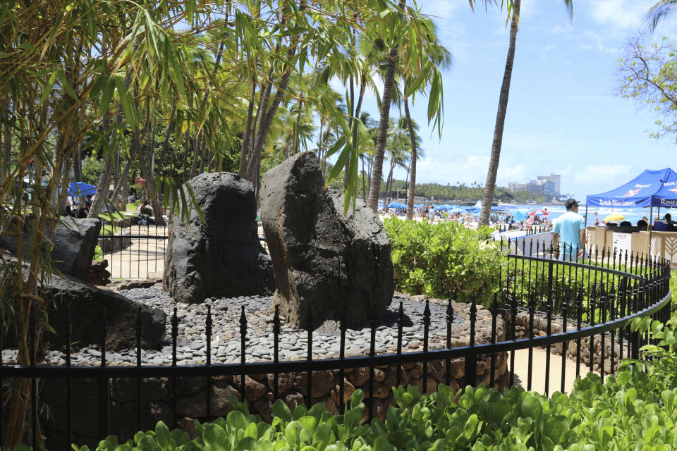 The Kapaemahu stones are seen at Waikiki beach in Honolulu on Tuesday, June 28, 2022. A new exhibit at Honolulu's Bishop Museum draws attention to the stones which honor four "mahu" healers from Tahiti who visited Hawaii more than five centuries ago and highlights gender fluidity's deep roots in Polynesia. (AP Photo/Audrey McAvoy)