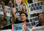 Raphael Wong, of the League of Social Democrats, chant slogans during a protest on China's National Day of celebrations in Hong Kong on October 1, 2016
